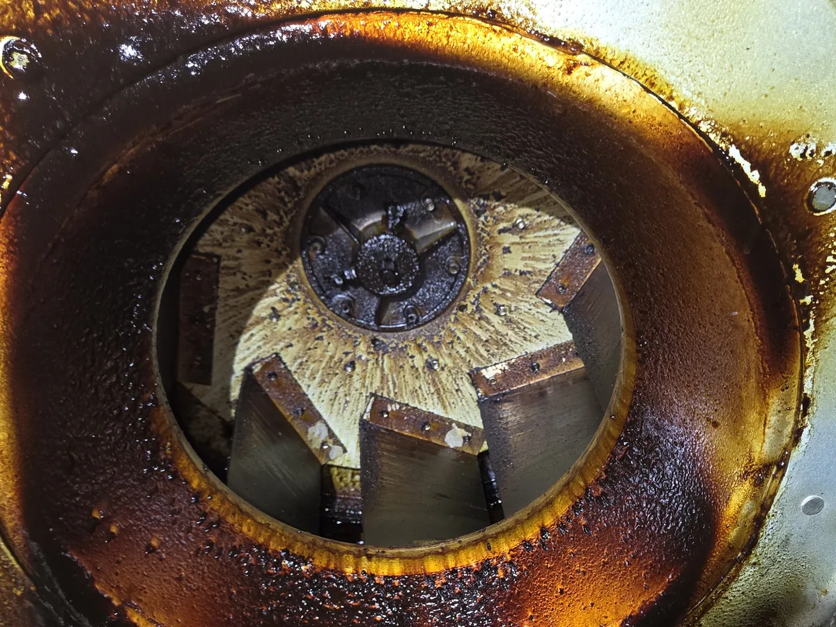 Exhaust fan wheel and housing caked in baked-on grease, before cleaning